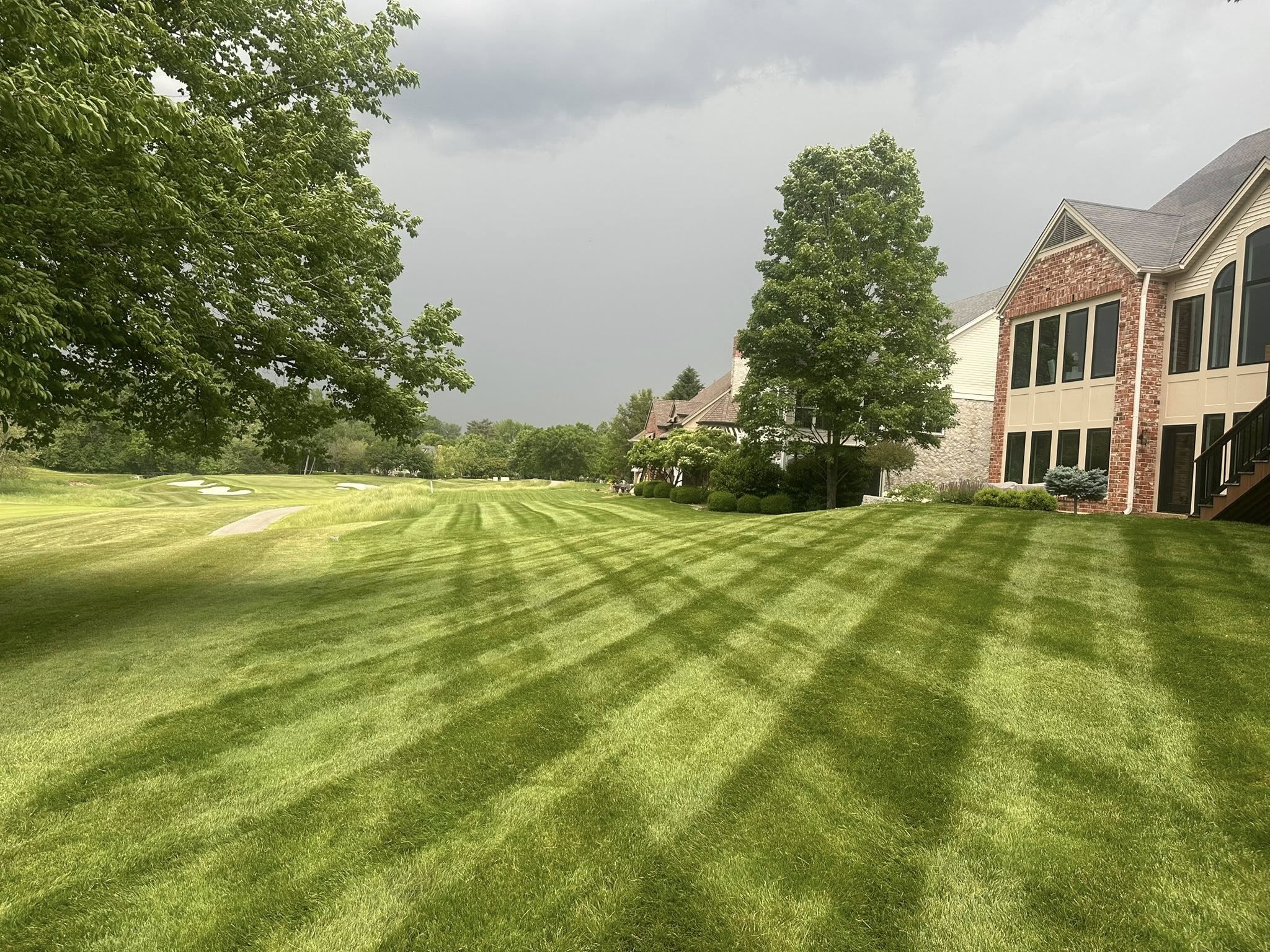 Estate lawn beside a brick home